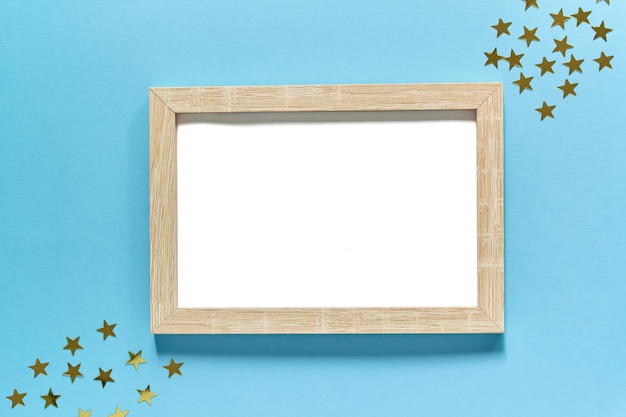 frame with golden glitter confetti stars on blue.