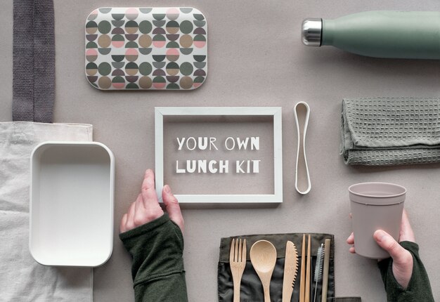 Frame with text, Creative flat lay, zero waste lunch concept with set of reusable wooden cutlery, lunch box kit.