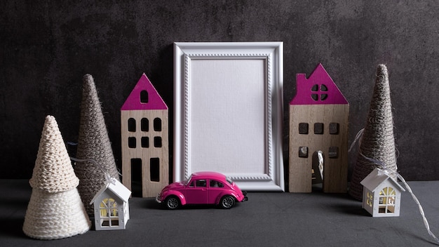 Frame wooden house car and knitted christmas trees on a dark\
background