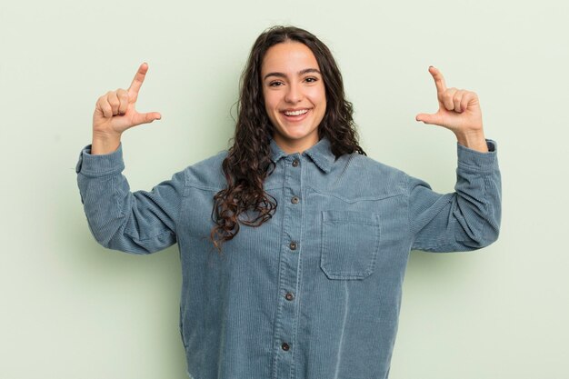 Photo framing or outlining own smile with both hands looking positive and happy wellness concept