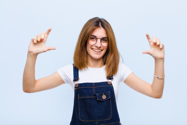 framing or outlining own smile with both hands, looking positive and happy, wellness concept