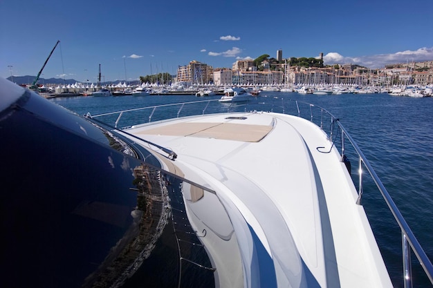 France, Cannes; CNM CONTINENTAL 80 luxury yacht in the port, view of the bow and the town