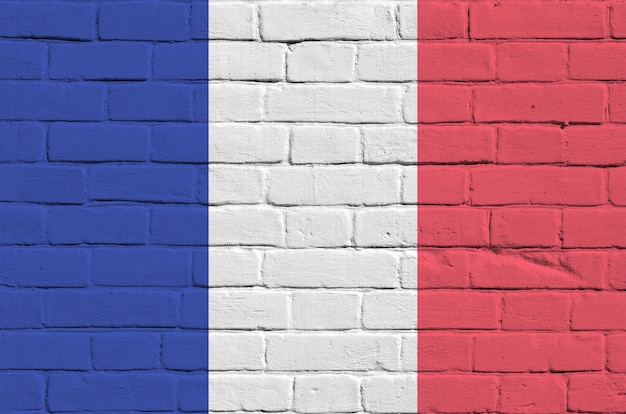 France flag depicted in paint colors on old brick wall. Textured banner on big brick wall masonry background