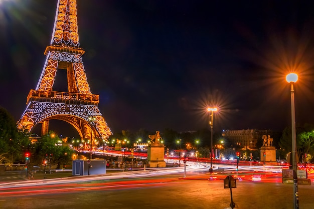 France, Paris. Night traffic and the luminous Eiffel Tower