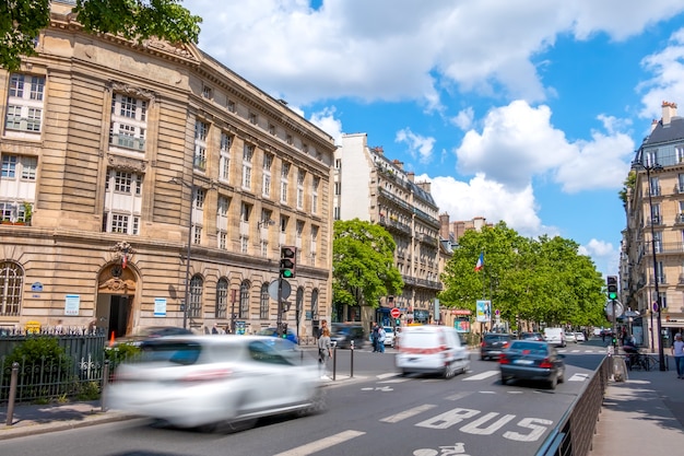 France, Paris. Street in the city center with busy traffic. Sunny summer day