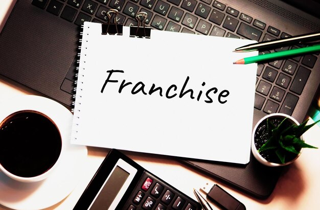 Photo franchise is written on white piece of paper franchise growth corporate business retail concept