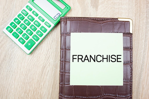 Photo franchise text concept with calculator franchise text financial business concept