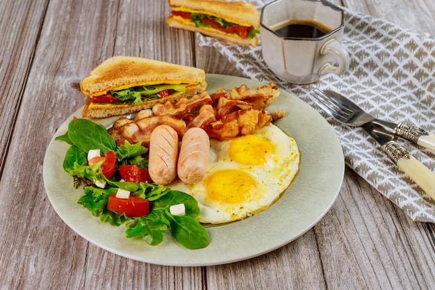 Franks, fried eggs, bacon and salad for breakfast.