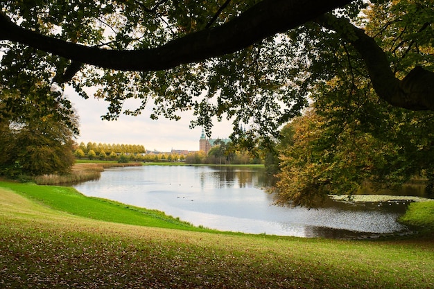 Frederiksborg Castle Park in autumn with mighty deciduous landscaped lake