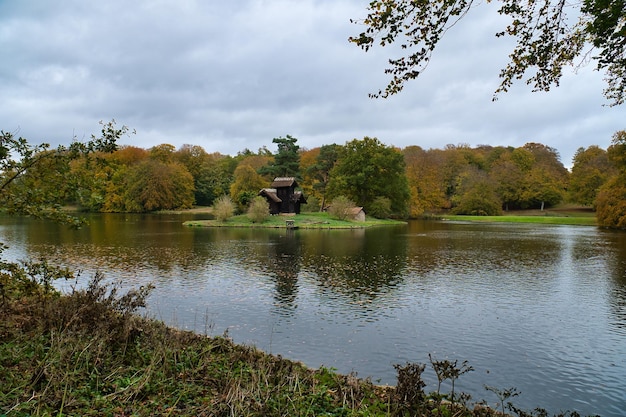 Frederiksborg castle park lake with island on which the wood Louises stands