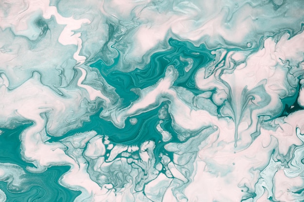 Free flowing green and white paint. Marble background or texture. Abstract fluid art.