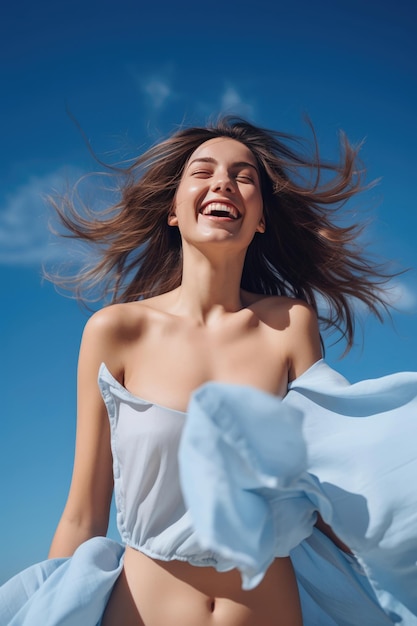 Free laughing young woman against the blue sky