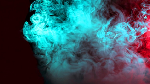 Free photo abstract red and turquoise smoke on black dark background