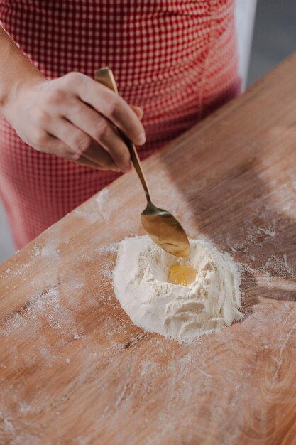 Free photo closeup person cutting pastry with machine