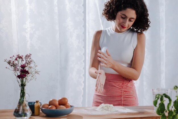 Free photo closeup person cutting pastry with machine