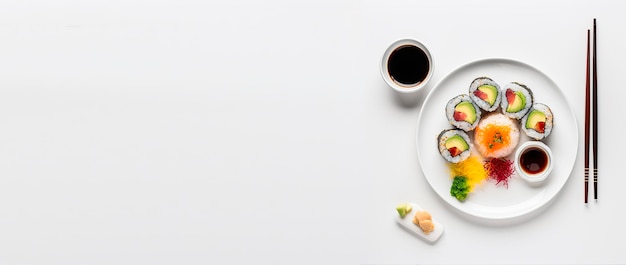 Free photo sushi in white plate and white background Top view shot and copy space