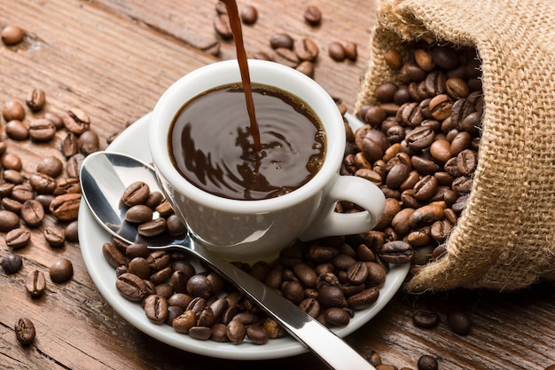 Free picture of coffee beans is on the plate and the cup of coffee