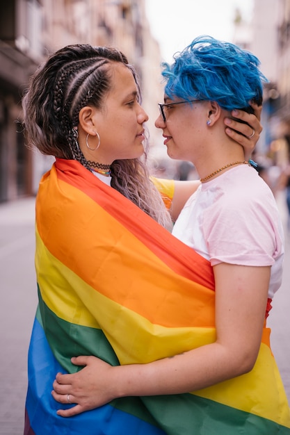 Free powerful women showing lesbian love without any shame wrapped in a gay flag.