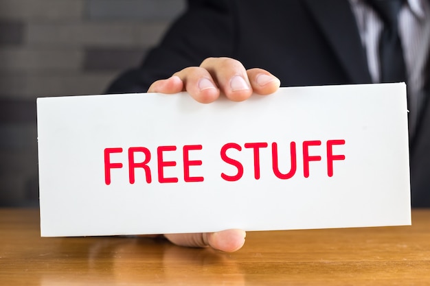 Free stuff, message on white card and hold by businessman