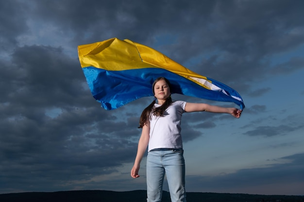 free teen girl in ukraine child with flag of ukraine kid with ukraine flag on sky background