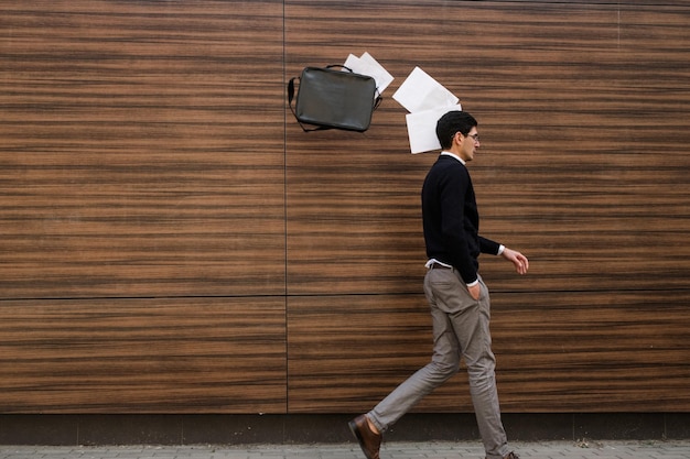 freedom carefree business man throws papers in the air. he is fed up with work. copy space concept