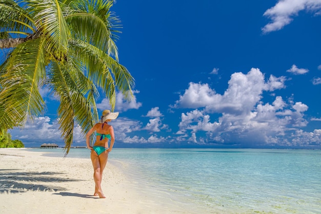 Freedom, carefree wallpaper woman relaxing tropical paradise beach with palm trees and turquoise sea