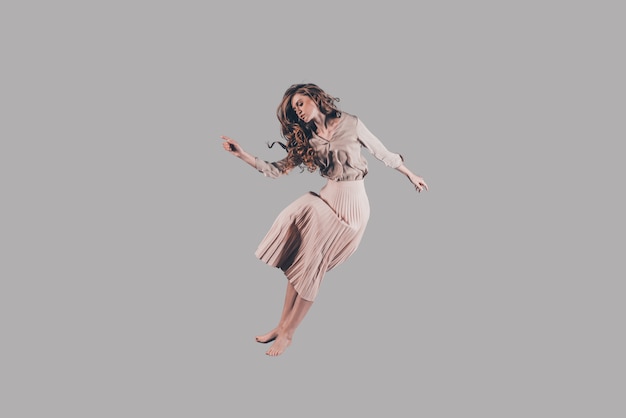 Freedom in every move. Studio shot of attractive young woman hovering in air