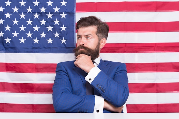 Freedom and liberty American businessman Serious businessman on american flag background Businessman with thoughtful look Brutal businessman in formalwear Formal fashion Business dress code