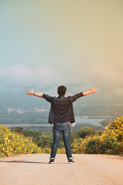 Freedom traveler man standing with raised arms