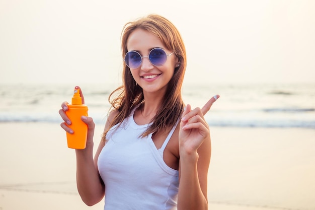 Freedom and woman independence concept.Happy young girl on the tropical beach.Happy female model during summer vacation enjoying the sea breeze and fresh air.spf and sun block spa