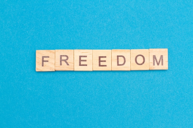 FREEDOM word from wooden blocks isolated