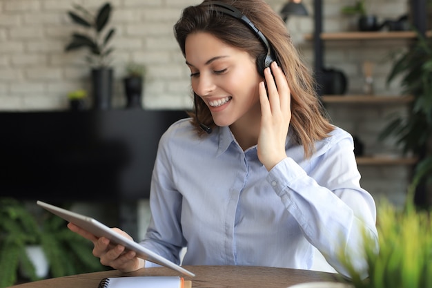 Photo freelance business women using tablet working call video conference with customer in workplace at home.