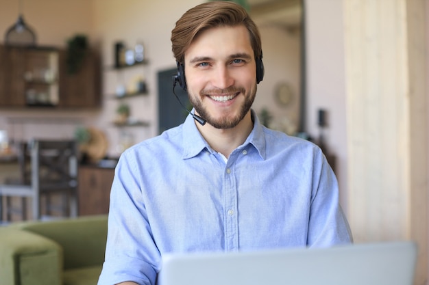 Freelance operator talking with headsets and consulting clients from home office.