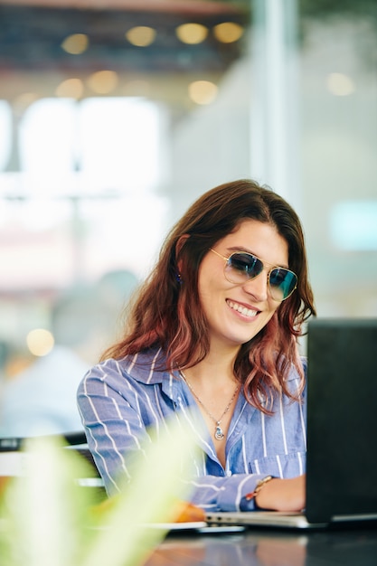 Freelance woman working in cafe