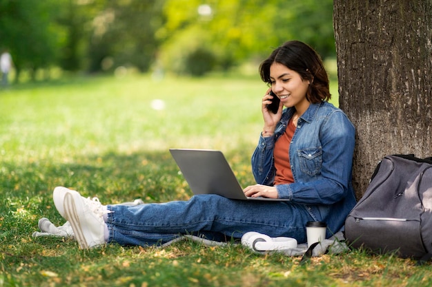 Freelance Work For Students Arab Female Using Laptop And Cellphone In Park