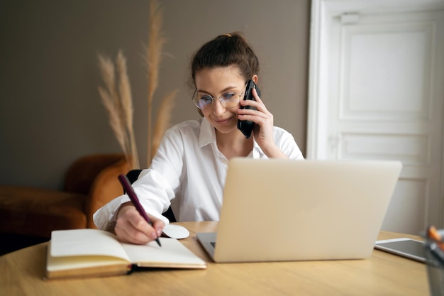 Freelancer formal wear in office uses laptop company report