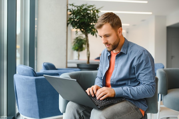 A freelancer man works with a laptop in a work coaching office