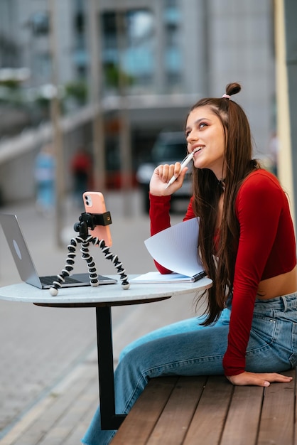 Freelancer woman in a summer cafe doing remote work