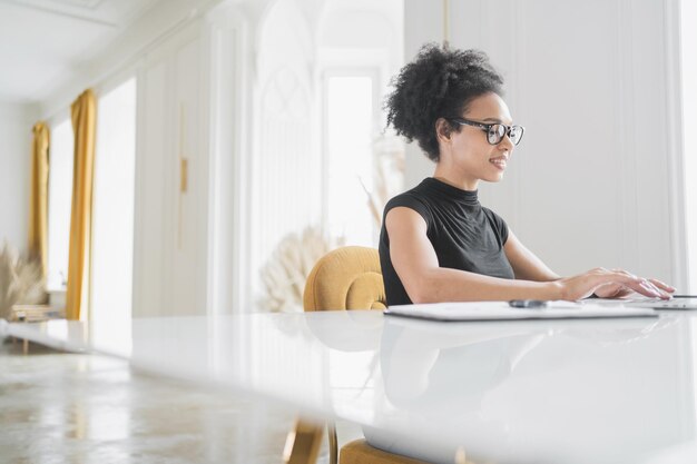 Freelancer woman working in an office workplace coworking space laptop on the table finance in the company