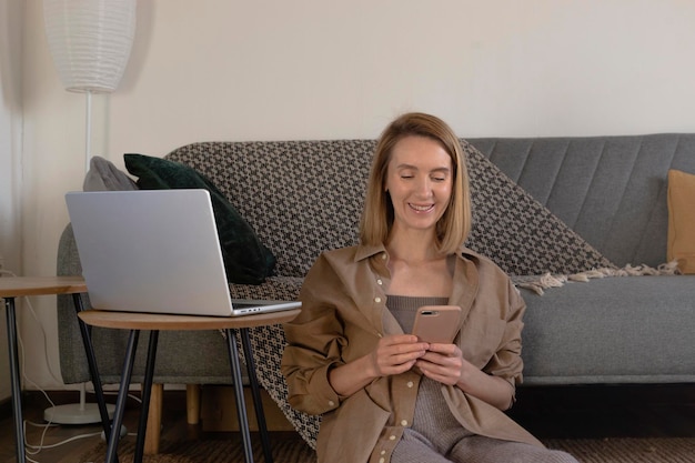 Freelancer woman working and relaxing at home in living room