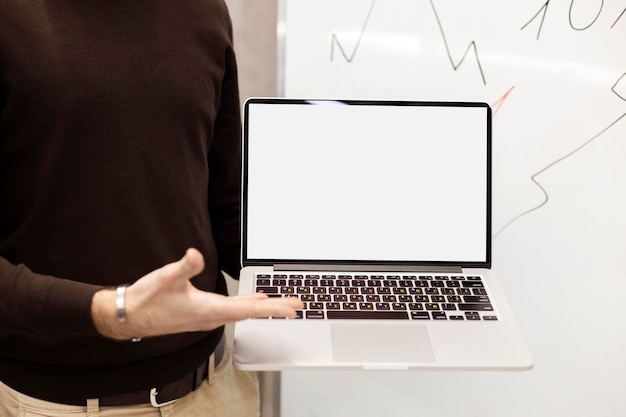 Freelancer worker using laptop typing working on online project standing in modern office