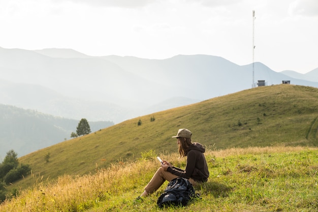 Freelancer young woman works with tablet online outdoors