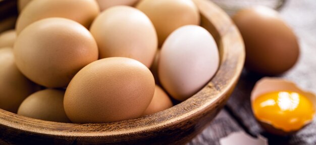 Freerange chicken eggs in handmade rustic wooden bowl organic rustic cuisine