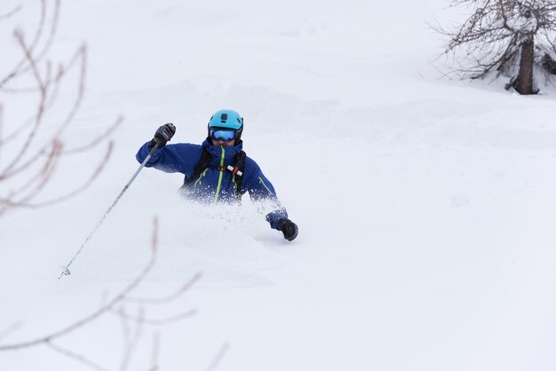 freeride skier skiing in deep powder snow