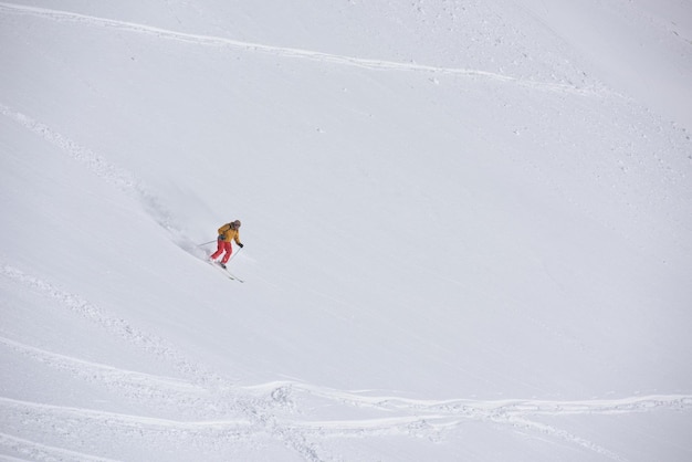 freeride skier skiing in deep powder snow