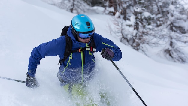 freeride skier skiing in deep powder snow