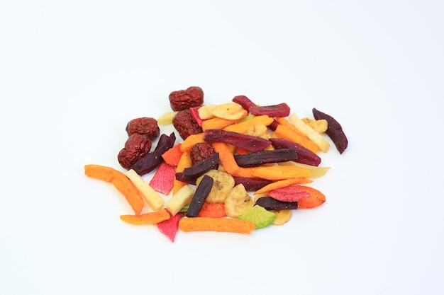 Freeze dried colorful crispy fruits and vegetables over white background. Mixed dry food for health