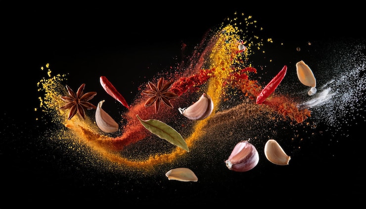 Photo freeze motion of flying spices on black background studio shot