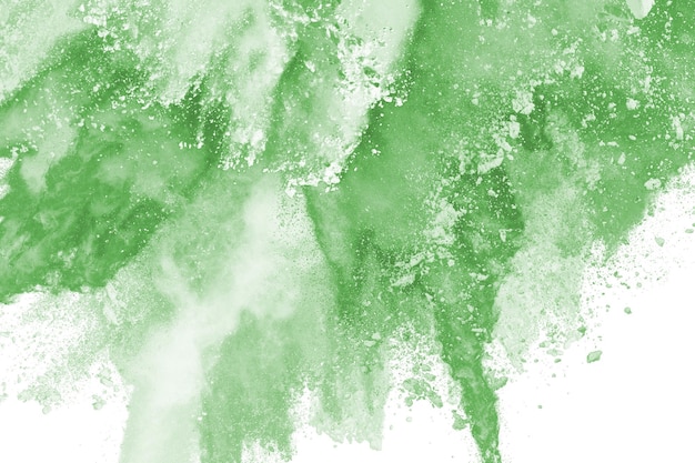 Freeze motion of green powder explodingthrowing orange dust on