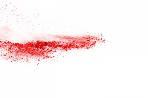 Freeze motion of red powder exploding, isolated on white background. 